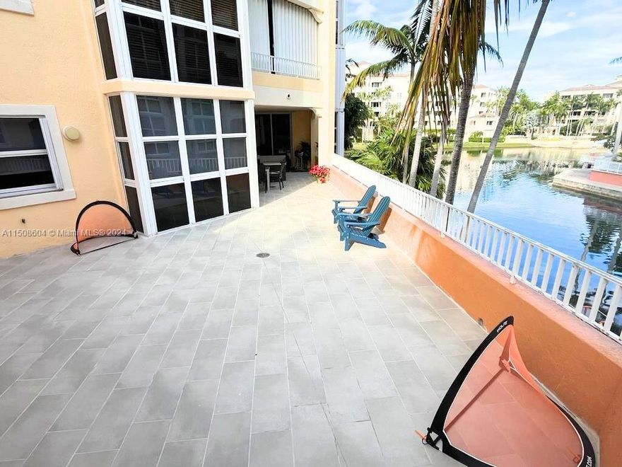 Enjoy the perfect blend of comfort and luxury in your own house-sized condo. Private direct entrance leads to a foyer with double doors which opens to the spacious living areas. Each of the three bedrooms with en-suite bathrooms. The master suite holds two walk-in closets and a spa-like bathroom. Work from home in the comfort of your dedicated office area, now also placing a music studio. Large lake-view eat-in kitchen. Generous laundry room ensures convenience, while ample storage keeps everything organized. Step onto the expansive 729-square-foot lakefront terrace, your very own playground bathed in sunshine, perfect for children to play. Resort-style amenities: Pools, Restaurants, Fitness Center, Spa, Beach Club, Tennis Club, 3 new Paddle courts and more.