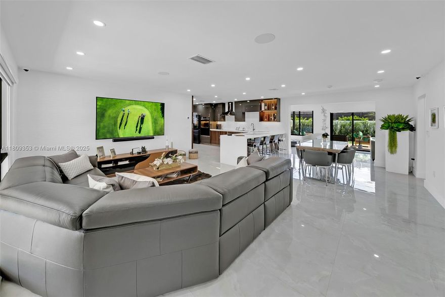 Stunning one-of-a-kind fully remodeled home in the heart of Cooper City! Reimagined in 2024 with no expense spared, this 4-bedroom, 2-bath residence features a sleek modern design, brand-new roof, impact windows & doors, and top-of-the-line finishes throughout. The custom European-style kitchen showcases premium cabinetry, quartz counters, integrated appliances, and LED-lit glass displays. Spa-inspired bathrooms, frameless glass showers, and designer tile. Enjoy large format porcelain floors, custom window treatments, and a luxurious primary suite. The backyard is an entertainer’s dream with a modern pergola, and travertine patio over turf. Gated side access fits a boat or extra vehicle. Top-rated schools. Truly a rare offering in this highly sought-after neighborhood!