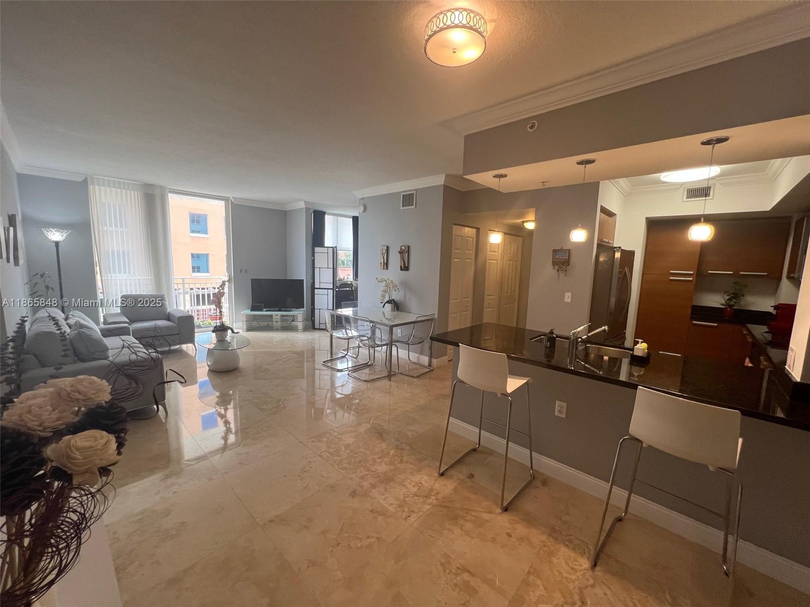 Three bathrooms (one of the bedroom is a large den with window and closet), plus two walk-in closets, washer and dryer inside, and an open kitchen with granite countertops and stainless steel appliances. This residence also features a private balcony with a gorgeous city view. Located in the heart of Coral Gables, the renowned "City Beautiful," this 2005-built apartment combines modern comfort and elegance. It is surrounded by excellent restaurants, schools, and hospitals—many within walking distance—and offers luxurious amenities such as a swimming pool, clubhouse, jacuzzi, gym, and more. The unit includes two parking spaces and guest and 24/7 security, rentals are allowed anytime, providing great flexibility. A perfect place to enjoy the charm and convenience of Coral Gables.