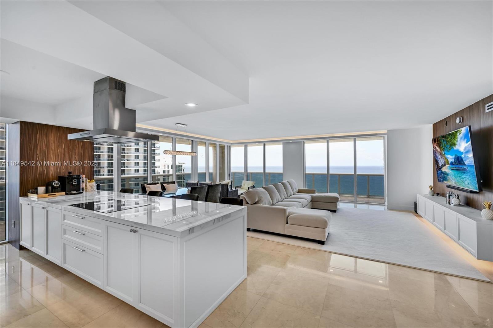Fully remodeled & professionally decorated NE corner unit with stunning direct ocean views. This 3BD/3.5BA Model B offers 2,078 SF of luxury living, a wraparound balcony, Crema Marfil marble floors, drop ceiling, electric blinds & recessed lighting. Spacious living area perfect for entertaining. Designer Florense kitchen with ceramic countertops, Thermador appliances, induction cooktop & wine cooler. All new bathrooms with book-matched floors/showers, Grohe fixtures & Kohler water closets with heated seats. Beach Club offers 5-star resort amenities: 5 heated pools, 50,000 SF spa, gym, 24-hr valet & security.