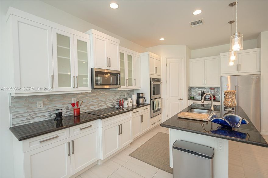 Enjoy refined single-family living with serene, unobstructed views from the home’s most desirable areas, including the family room, kitchen, living room, and main entrance. This stunning open-concept floor plan is filled with abundant natural light, creating an elegant and inviting ambiance throughout. The spacious backyard is ideal for outdoor entertaining and offers ample room to build a pool. The home features exceptional additional spaces, including a versatile first-floor room ideal for a private office or guest suite and a generously sized den on the second floor. All closets are custom-designed with high-end finishes, providing superior organization and style. The property is impeccably maintained and showcases beautiful kitchen finishes with striking quartz countertops that add a sophisticated modern contrast. This exceptional residence seamlessly blends luxury, comfort, and functionality, offering a rare opportunity to own a move-in-ready home designed for elevated living and lasting enjoyment.