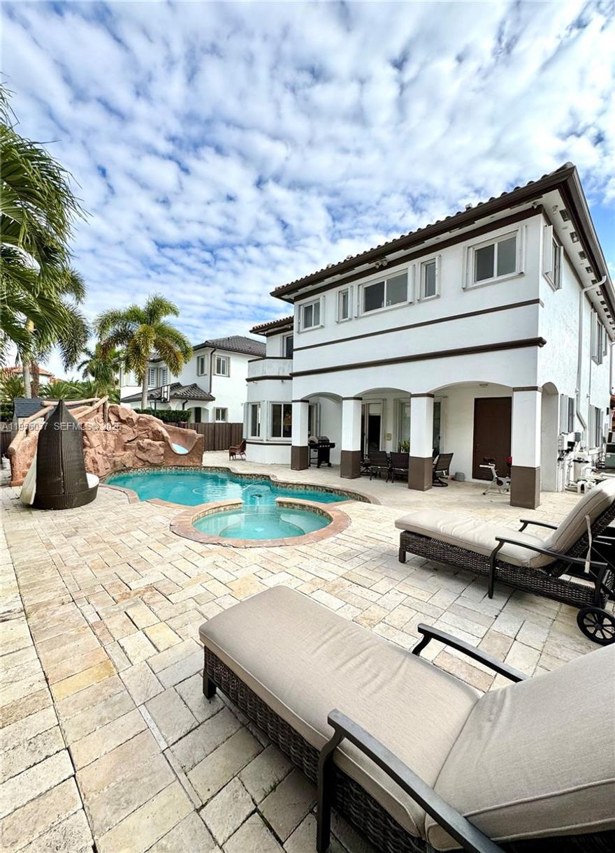 NO HOA! Single-family home offering 3,137 SF of living area with a 5-bedroom, 4-bathroom layout. Private parking space suitable for boat, RV, truck, or multiple vehicles. Property features include ceramic tile flooring throughout, a marble entry foyer, high ceilings, and marble stairs with aluminum handrails. Spacious kitchen with island and stainless-steel appliances. Laundry room with sink.

The first floor includes 1 bedroom and 1 full bathroom. The second level features 4 bedrooms and 3 bathrooms, including an impressive primary bedroom with two separate private toilet areas, large bathtub, shower, and double-sink vanity; 1 bedroom with a private bathroom, and 2 bedrooms sharing a Jack & Jill bathroom.

The backyard offers a private resort-style pool with jacuzzi, waterfall, waterslide, and marble pavers, ideal for outdoor enjoyment and entertaining. Additional features include a remodeled 2-car garage with modern epoxy flooring and updated lighting, as well as accordion hurricane shutters on all windows and glass doors. Property is conveniently located near shopping centers and major roadways. Easy to show! Schedule your private tour today.