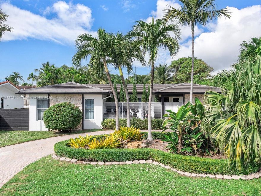 This tastefully upgraded home is centrally located in the exclusive gated community of San Souci Estates, in a quiet street just across from multimillion waterfront mansions. Sitting on a lot of over 11,000 sq ft, this house is filled with natural light and features 4 bedrooms, 2 and 1/2 bathrooms, a large office space, an open kitchen overlooking a spacious dining room, an oversized living room and a two car garage. The covered patio and the large swimming pool are perfect for entertaining. The roof was replaced in 2020 and solar panels were added. Other features include a paved circular driveway that fits up to 5 cars, new fence, a top of the line water filtration system, an outdoor grill oven, level 2 EV car charger, impact windows and a built in espresso machine. An absolute gem!