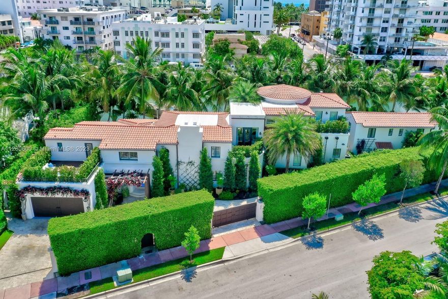 "La Joya" (the jewel) w/300 ft of water in most vibrant neighborhood on M.B. Double height ceilings. Open and airy. Swanky bar opens to plush poolside terrace & invites you to take the party outside, all privatized by lush gardens. Oversized pool and dock w/ boat lift. Huge impeccably designed kitchen is truly the heart of the home. Volume ceilings, massive Sub-Zero, 2 lrg wine towers. Dramatic master + sitting rm. 13ft ceilings, wall of glass, + 3 terraces. 4 bds up 1 dwn+ office/library. 1 bd, 1 ½ bth guest villa w/private patio. 2 car garage, private gated entry court. Full surveillance & security system. Walk to shops, renowned hotels, restaurants, beach clubs & more. 5 min to Lincoln Rd, golf, Sunset Harbor & Faena Dist. 15 min to Int. airport.