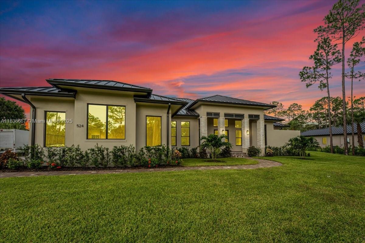 Nestled on 2.5 acres of 100% upland in Golden Gate Estates, this home offers luxury, privacy, and functionality. Featuring an open layout with soaring ceilings, modern finishes, and a living room with a custom feature wall, gas fireplace, wet bar, and built-ins. The kitchen includes a hidden prep area and walk-in pantry. The study with closet works as a guest room. The owner’s suite has a spa bath, outdoor shower, and direct access to the screened pool with fireplace and grill. No HOA and plenty of land to expand.
