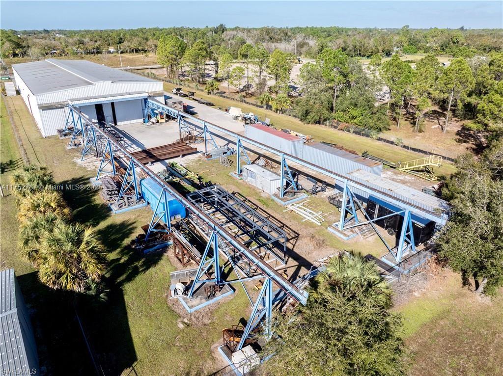 This is a rare opportunity to own a well-established structural engineering and production fabrication facility in the heart of LaBelle, Florida. Situated on 2.3 acres and surrounded by chain link fencing, the property features a 20,000 sq. ft. metal building equipped with a wide range of heavy-duty and specialized equipment, available for negotiation. The property is perfectly suited for manufacturing, fabrication, or industrial operations. Already in place are OSHA approved employee restrooms along with air-conditioned office space consisting of both up and downstairs and totaling to approximately 2000 +/- sq ft, inclusive of the 20,000 +/- sq ft building. A prime opportunity for businesses looking to expand or establish themselves in a highly accessible yet low-traffic area.