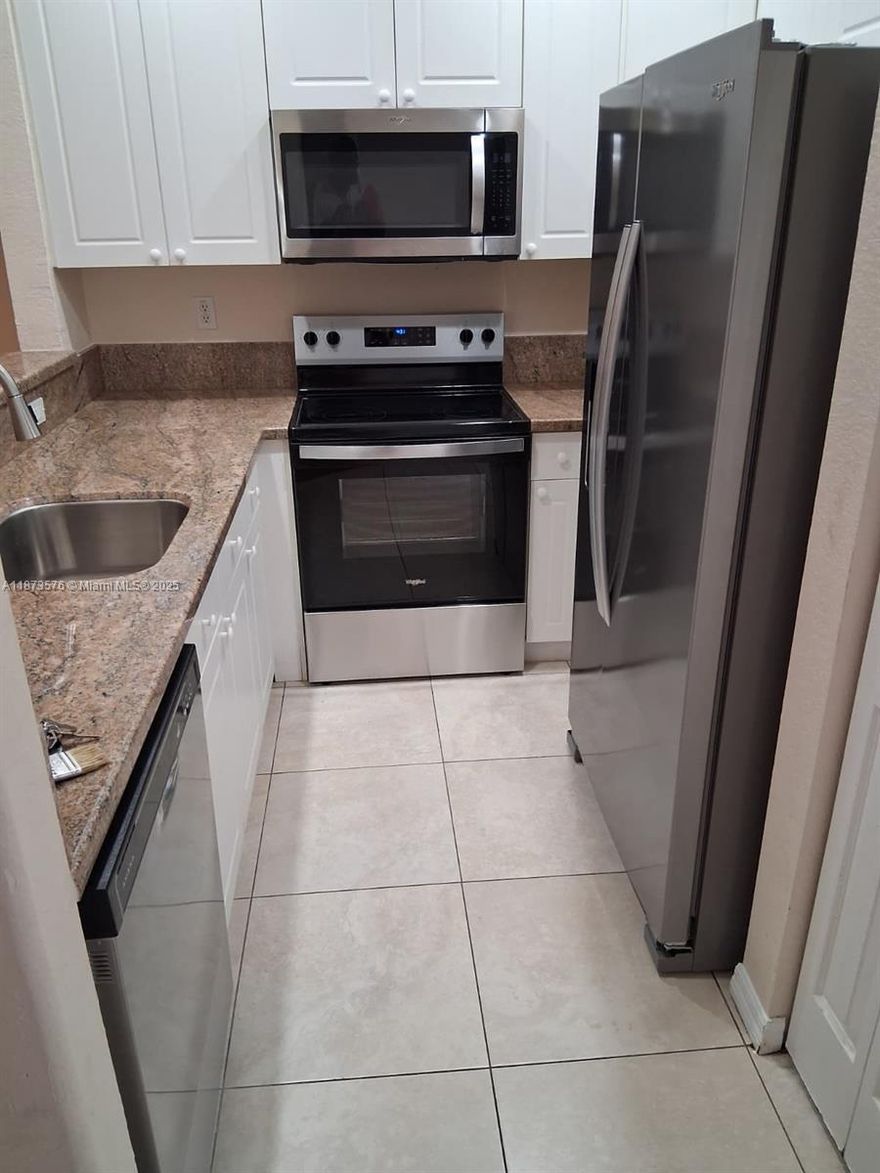 Back on the market with brand new granite kitchen countertops and stainless steel appliances!  Spacious 3 bedroom, 2.5 bath in gated Merrick Preserve, with community pool.  All bedrooms upstairs, separate living, dining, and family rooms; tile and laminate floors throughout, washer and dryer inside the unit.