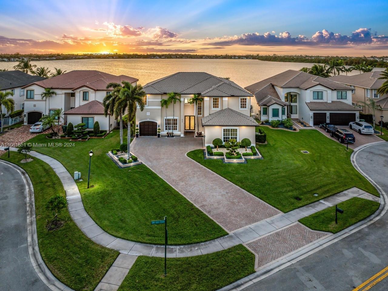 Elegant home on an oversized lakefront cul-de-sac. Expansive backyard with room to build a large pool & outdoor area of your dreams. Spectacular sunset views overlooking the one-mile lake. The oversized windows allow for natural light throughout the home. The beautifully landscaped & lighted front of the home includes an extended driveway that can accommodate up to 12 cars. The open & spacious floor plan has a large living & family room with 21 ft ceilings & incredible lake views. The home is a 4/3.5, has a separate office & an open loft area that can be converted to an additional bedroom. The gorgeous gourmet kitchen includes wood cabinets, s.s. appliances, granite countertops & breakfast area. Gated community with amenities including a resort style pool, 6 tennis courts, BBQ & Gym.