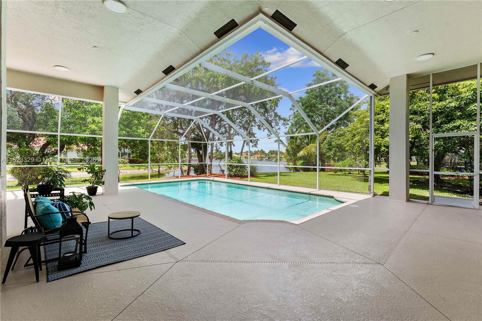 Nestled among mature landscape is an exceptional lakefront property located in *THE ISLES*, Coral Springs' most sought-after gated community. This meticulous home offers the perfect blend of privacy and entertaining space, ideal for a discerning buyer. Once inside, you'll be greeted by an open living plan featuring vaulted ceilings and a warm palette of ITALIAN marble flooring that flows throughout the social areas, creating a sense of elegance and sophistication. The chef-inspired kitchen is a highlight with Sub-Zero, Miele, and Wolf . The sliding glass doors provides breathtaking lake views & offers seamless access to the outdoors & oversized, screened-in pool area with mature landscaping providing privacy. The Master Suite is designed as a true retreat, complete with a spa-like ensuite.