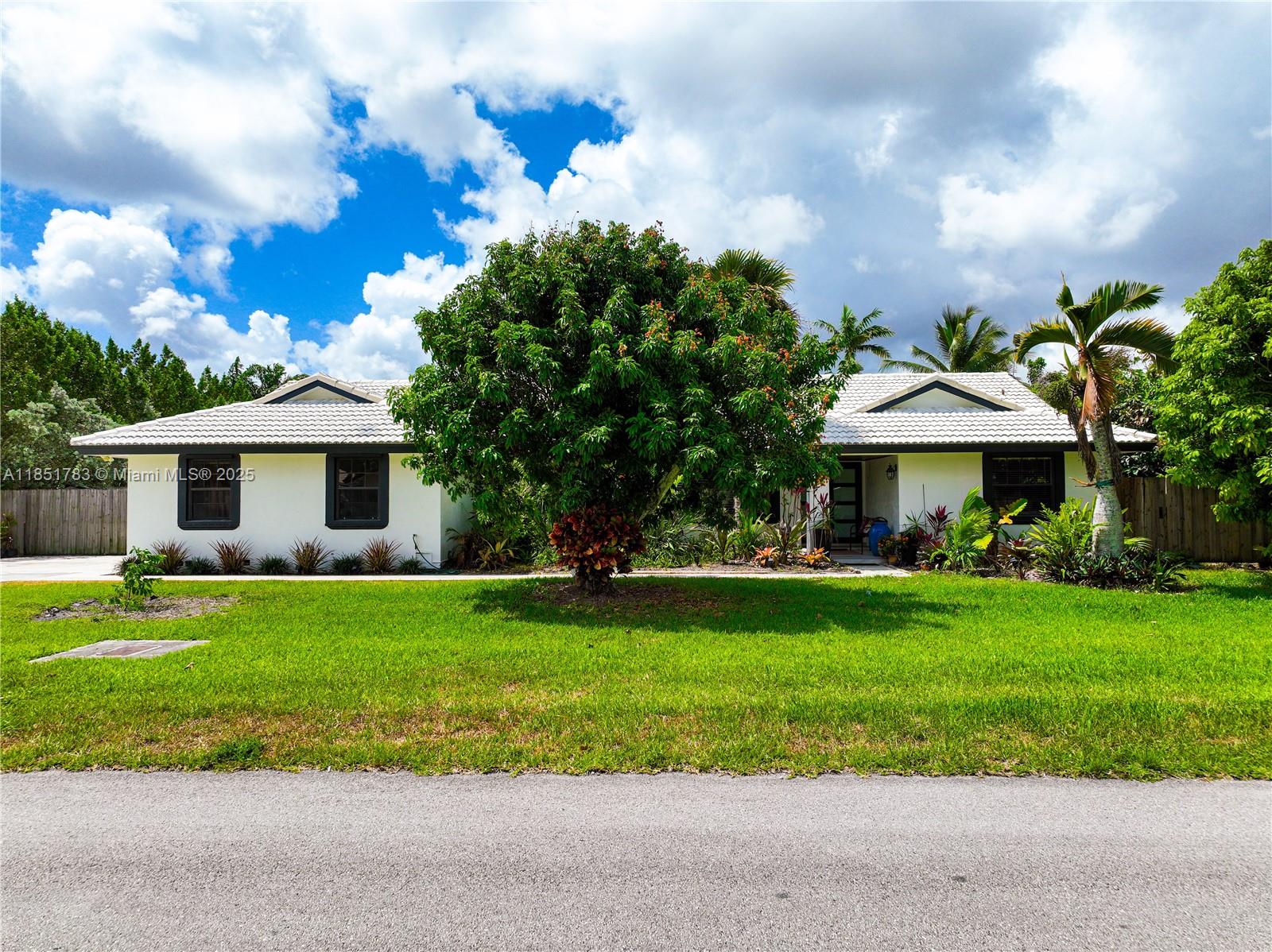 Stunning updated single-family home on an oversized 17,360 sq. ft. lot. This property features 4 bedrooms and 2 full bathrooms. A spacious open floor plan seamlessly connects the living, dining, and kitchen areas. The kitchen boasts quartzite countertops, ample cabinetry, and an under-counter beverage cooler. The primary suite offers an en-suite bathroom with dual vanities and a walk-in closet. Extra room, which is ideal for an additional bedroom, office, or gym. Step outside to a private oasis with a screened patio and fully fenced backyard with fruit trees and space to build a pool or park an RV/boat. Two-car garage. No HOA! Conveniently located near top-rated schools, dining, shopping, and minutes from the Florida Keys. Enjoy an immersive 3D virtual tour. May the Force be with you!
