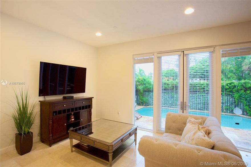Tri-level beautifully furnished home with 3 parking spaces in prime Fort Lauderdale. This home features sophisticated design and fixtures, ceramic and wood-like flooring and ceiling fans throughout. Open concept kitchen offers brand new high-end stainless steel appliances, granite counters, and plenty of dark wood cabinets plus a breakfast bar. Separate dining area and french doors in living area lead to fenced brick patio and private heated pool. Master BR has en-suite with garden tub and walk-in closets. Fantastic views from the private top floor terrace and just minutes to Las Olas, Flagler Village, and the beach plus all that Victoria Park offers.