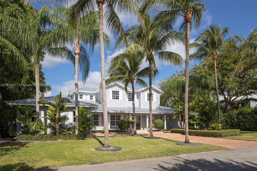 A special Key West estate on a beautiful canal-front block in the heart of Pinecrest. This home exudes both luxury and warmth with a thoughtful floor plan, soaring ceilings, abundant natural light, and tasteful finishes indoors and out. The heart of the home is the recently renovated kitchen with gas range, wine fridge, breakfast area, and picture window out to your backyard oasis. Enjoy the breeze on your wraparound front and back verandas, grill at the new summer kitchen, or splash in the sparkling pool. Oversized primary suite offers two walk-in closets, double vanities, and standalone tub. Stone and hardwood floors throughout, plantation shutters, Chicago brick driveway, and two-car garage. Perfectly located near top private and public schools. A home like this rarely comes along!