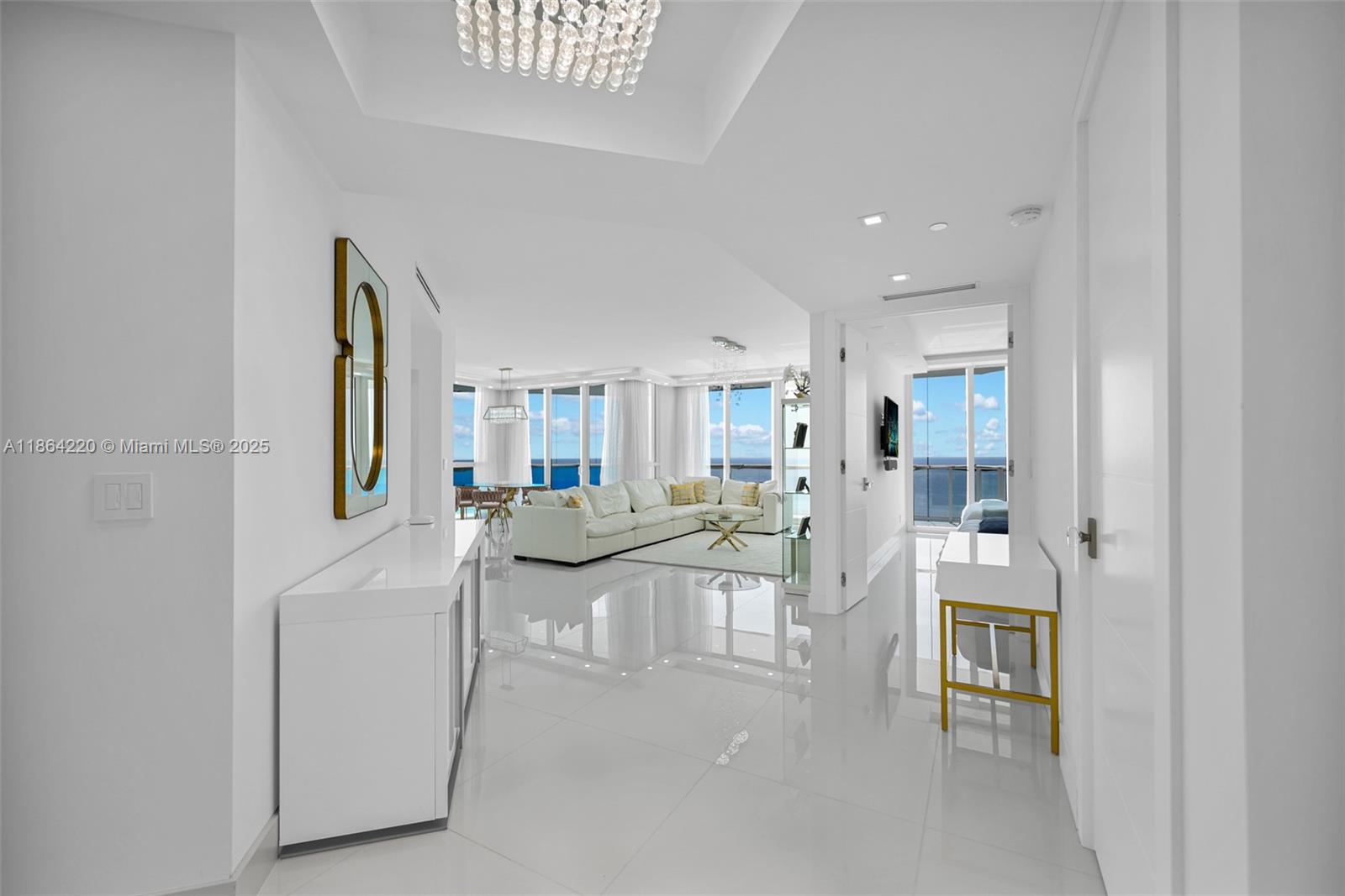 Welcome to this beautifully remodeled Penthouse that has undergone a complete transformation with direct ocean and city views. This turn-key features an open floor plan with an abundance of natural light flowing through impact hurricane oversized windows. With 10 feet ceilings, custom closets and lighting, beautiful white porcelain floors create an inviting ambiance, perfect for gathering with family and friends. Custom modern kitchen, with a large central island, is the heart of the space, marble countertops, café appliances. The adjacent dining area offers ample seating for family meals or entertaining guests. True Luxury Resort Style Living within a building that features; Full Service Private Beach Club, private restaurant, café, 24 hour security, concierge , valet.