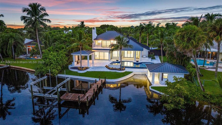 Wide Water River View - Wake up everyday to one of the most long and serene Loxahatchee River Views. This home has been updated and renovated. The moment you enter you will see Paradise that is River living. Enjoy the River Life poolside with your infinity edge pool and spa, outdoor patio, summer kitchen and putting green, dock with lift and a bonus water entry for launching water crafts. Chef's kitchen with quartz countertops, stainless appliances, white cabinetry, dining room with wine wall and chillers. Spectacular River views from the Primary Bedroom with balcony, huge walk-in closet, dual sinks and tons of natural light. This home will not disappoint.