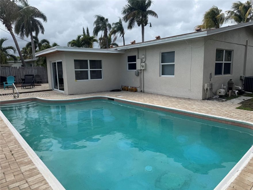 This move-in ready, one story pool home is renovated and offered furnished. Featuring a spacious backyard with a private pool and space for outdoor entertaining, this residence is designed for easy South Florida living. The open-concept kitchen includes stainless steel appliances, granite countertops, and flows into a separate dining area overlooking the pool and backyard. The spacious living area offers an inviting layout with a desirable split-bedroom floorplan, with the primary bedroom and ensuite bathroom on one side of the home, while two bedrooms and a full bath are located on the opposite side. Additional features include hurricane-impact windows, interior laundry, circular driveway, roof (2017), A/C (2017), and updated pool motor (approx. 2 years old). Exterior stucco, wood trim, and paint were completed approximately 6 years ago. Great east location, just 2 blocks west of Federal Highway, minutes to the beach, & close to stores, restaurants, golf, boating & more.  Listing is subject to errors, changes, & omissions without notice, information in this listing is not warranted or guaranteed & must be confirmed by Buyer.