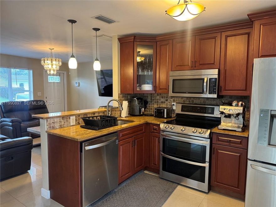 Renovated one story home with large in-ground pool. Move right into this furnished house and enjoy an open concept kitchen with stainless steel appliances and granite counters, separate dining area with view of pool and backyard/deck, and spacious living room. The master suite is on one side of the house and the other two bedrooms and bathroom are on the opposite side. Split bedroom layout is ideal for privacy. All furniture included: master bedroom just 1.5 years old & reclining mattress about 6 months old, big living room tv a few months old. The south facing backyard has a large pool and lots of space for lounging or barbecuing outside. Other features include: circular driveway, roof in 2017, a/c in 2017, laundry inside house, hurricane windows and doors, 2 yr old motor for pool and exterior stucco, wood trim and painting completed about 6 years ago. Great area, 2 blocks west of Federal Highway, minutes to the beach, and close to stores, restaurants, golf, tennis, boating and more.  Listing is subject to errors, changes, & omissions without notice, information in this listing is not warranted or guaranteed & must be confirmed by Buyer.