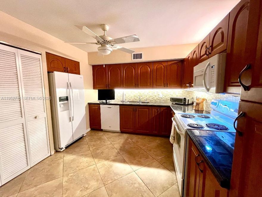 IDEAL LOCATION, Overlooking Gorgeous Pool & Gardens, smack in the middle, on the 5th floor, this Stunning 2BR/2BA, set up as Conv, w/pocket doors. Updated Kitchen, w/LOTS of Space!  Washer/Dryer, relocated into hallway, creating LARGE Storage Area in Kitchen, which has been tastefully renovated. Oversized Marble Tile, exc Master has carpet. Just waiting for a little TLC, to bring it up to date! Large Screened in Terrace. Unique layout, w/endless possibilities. Htd Pool, Gym, Billiards, Library, Social Hall, Covd Pkg. Close to FTL Airport, Hard Rock Casino, 95, TY Park, Tpike, even the Beaches. Spacious apartment w/loads of potential.  Lovely walking paths, inside and around the complex, nestled in a 24/7, Secure gated Guarded community...in Beautiful, safe Emerald Hills. Several Houses of Worship within walking distance. Just waiting for a little TLC, to bring it up to date! Oversized Screened in Terrace.  Rental Restrictions - No Pets, exc Service Animals pending approval.