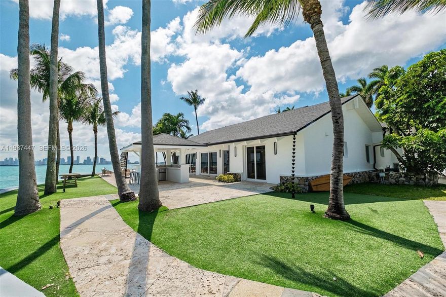 Enjoy refreshing bay breezes, breathtaking sunsets, and sweeping views of the Downtown Miami skyline from this serene 17,953 sq ft corner waterfront property, ideally located within the gated community of North Bay Island. A true haven for boating enthusiasts, the property features three boat lifts positioned along the side of the home - preserving unobstructed water views. Be the first to reside in this fully renovated residence from top to bottom. The main house offers 4 bedrooms and 3 bathrooms, including a primary suite privately set apart from the other bedrooms for added comfort and seclusion. The 4th bed, a transformed attic space, offers versatility - ideal as a children’s playroom, home office, or creative retreat. The home is complemented by a private guest pavilion suite and a covered poolside bar and showcases a spacious living area with dramatic high ceilings. Designed in a distinctive mid-century modern style, the property features clean lines, unique architectural elements, and a seamless indoor/outdoor connection. The gourmet kitchen is inspired by the vibrant blues of the surrounding water. Expansive driveway providing ample guest parking. Offering a rare combination of privacy, elegance, and the ultimate Florida lifestyle, this exceptional residence is just minutes from the beach, the Design District, and top-rated schools, including Miami Country Day. Available for annual lease, unfurnished. No short-term rentals permitted.