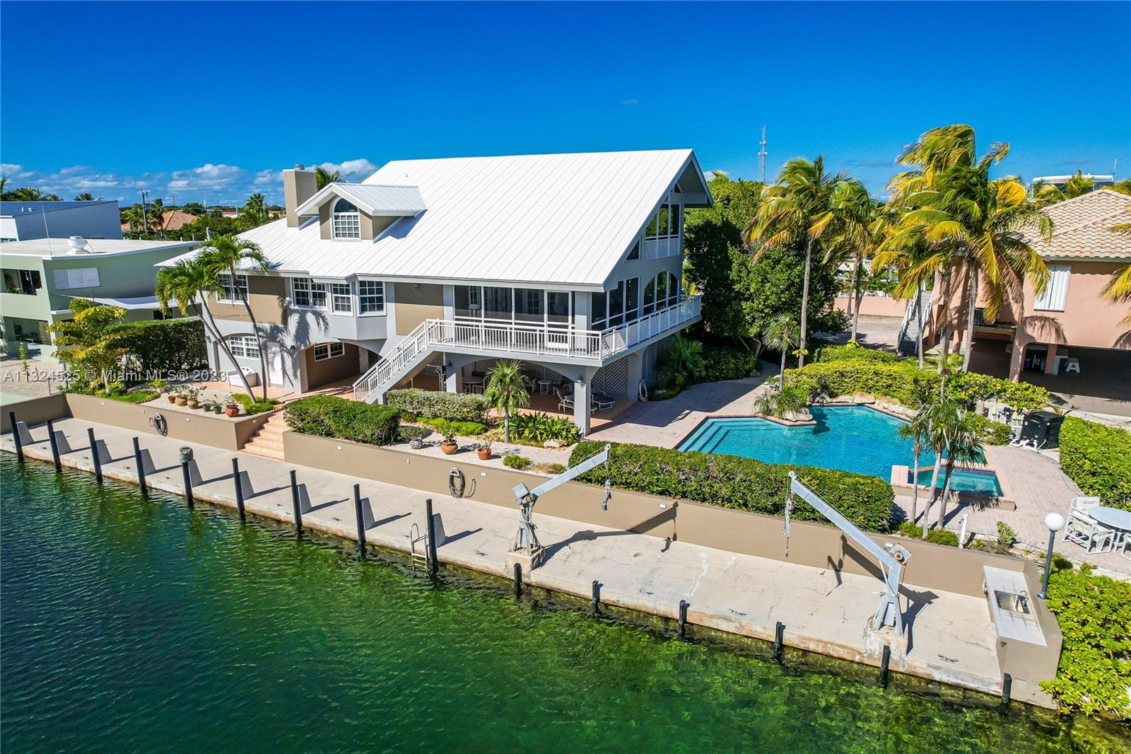 A yacht owner's delight, located in the most sought after area of Key Largo, Port Largo! This Solid CBS waterfront estate pool home boasts 120 ' of concrete dock and a 172 ' of deep waterfront, located on the main canal of Port Largo with views of Ocean Cay and the Atlantic Ocean! Instant ocean access with no bridges! Port Largo is the only neighborhood in Key Largo, ocean side that can accommodate yachts with a 6 ft. draft. Located on the terminus of a quiet cul-de sac- this corner lot property is fenced & gated. You will be delighted by the extensive brick pavered drive & the lovingly maintained gardens, with tropical foliage & specimen palms that grace the property. See Supplemental remarks or call the agent.