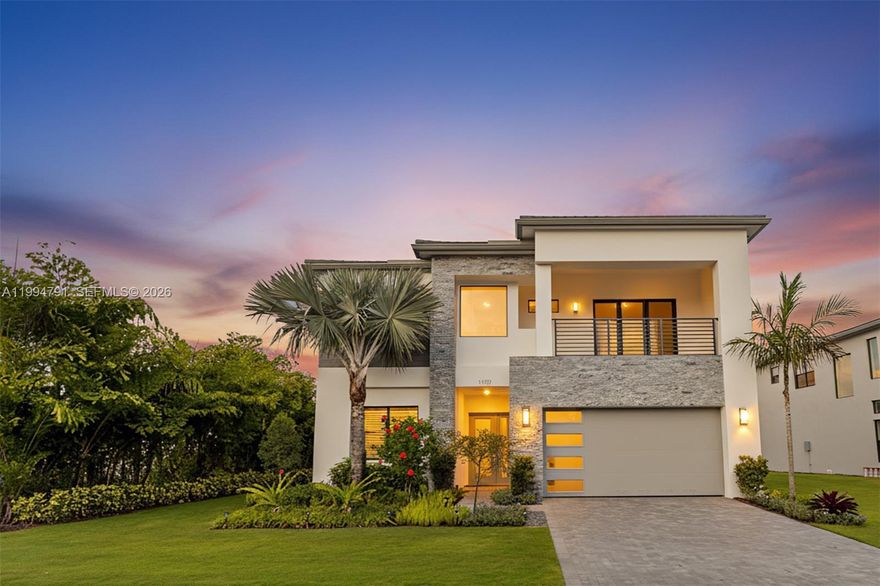 Perfectly positioned on lakefront lot 77 within Boca’s exclusive Lotus Edge, this exceptional Samoa Premium residence offers a prime setting, privacy, and a clean contemporary aesthetic finished in a sophisticated neutral palette that feels elevated yet easy to personalize. Enhanced by a tree-lined easement along the property’s edge and west-facing long-lake views with sunset backdrops, the setting is both serene and visually striking. The kitchen is appointed with an oversized quartz island, light wood-toned cabinetry, stainless steel appliances, double wall ovens, gas cooktop, and generous storage, all opening seamlessly to the great room and dining area with water views. The first-floor primary suite is thoughtfully positioned for privacy and complemented by a spa-inspired bath, while a main-level den/office adds flexibility. Upstairs, 3 bedrooms and 3 baths, together with a spacious loft and covered balcony, create an ideal layout for everyday living and elegant hosting. The garage is equipped with an electric vehicle charger. Per builder floor plan, the home offers approx. 3,249 interior sq. ft. and a large homesite with room for a custom pool. Lotus Edge offers a 39,000-square-foot clubhouse with pools, restaurant/bar, fitness and wellness amenities, racquet facilities, and indoor and outdoor sports. For buyers who want Lotus Edge without the wait for construction, this move-in-ready residence offers immediate enjoyment in one of Boca Raton’s most desirable communities.