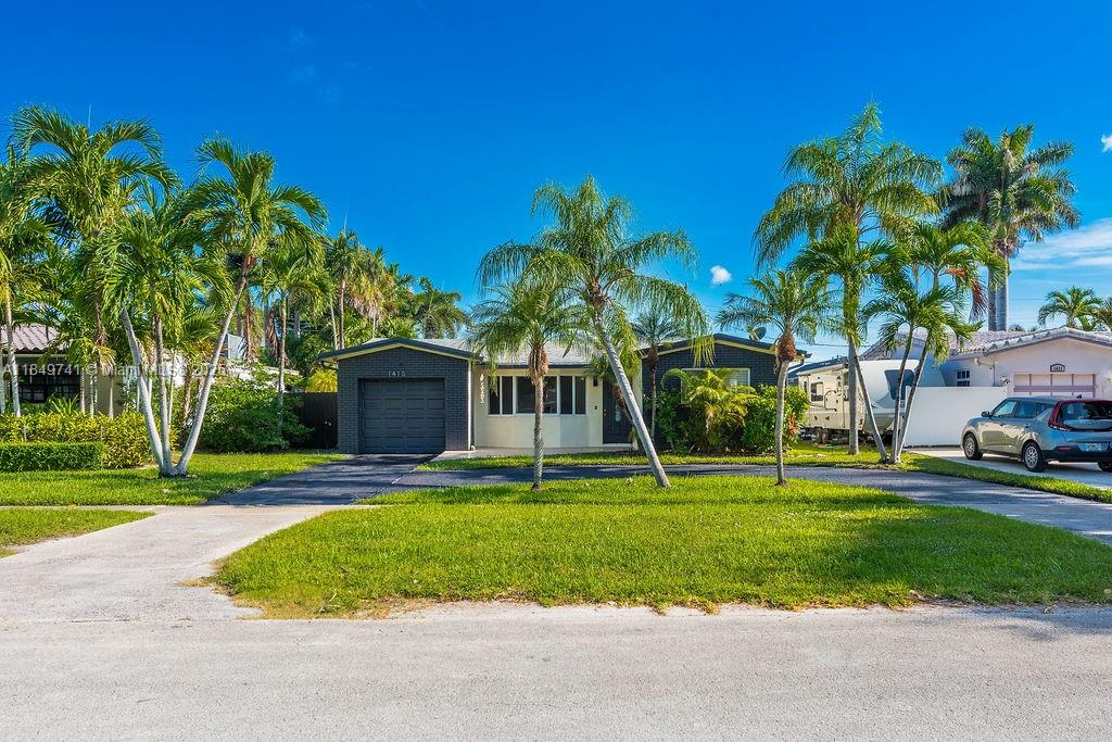 Beautiful 3-bed, 2-bath home with recent upgrades just minutes from the Ocean ,Publix, shops, and Hollywood/Ft. Lauderdale Airport! Featuring impact windows, new flooring, fresh paint, and updated electric, this home is move-in ready. The spacious primary suite offers patio access and a luxurious marble-tiled bath with a rain shower. The kitchen with an eat-in island shines with quartz countertops, stainless steel appliances, and a pass-through to the formal dining room. Outside, enjoy a large fenced backyard with a Jacuzzi tub, covered patio with NEW grill Perfect for entertaining and relaxing in your own privacy. Large circular driveway and 1 car garage for added space and extra storage space. Very Easy to show !