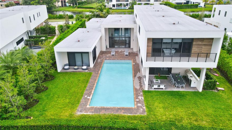 Absolutely stunning! exquisite residence in the highly sought-after enclave of BOTANIKO ESTATES. This luxurious haven is nestled on a sprawling 21,650 SQF of premium private lakefront lot, offering unparalleled tranquility & privacy. One of a kind at Botaniko. Step into opulence with the O5A model, spanning 7681 SQF across two stories. This masterpiece boasts 6 lavish bedrooms, each with its own ensuite bath, plus his & hers ensuites. The residence also features a media room,office/staff quarters & high-end appliances. The exterior is designed for lavish gatherings with a beautiful summer kitchen & a 40 FT salt water pool. This home is a luxurious, move-in ready gem in Weston, offering a perfect mix of “tranquility & accessibility”