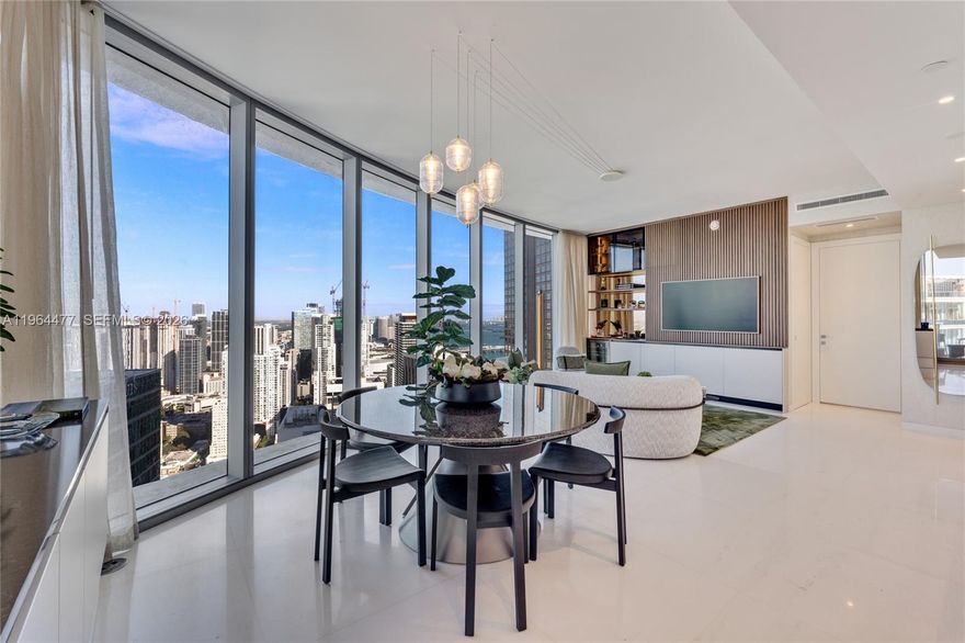 Enjoy elevated design and exceptional privacy from the 50th floor of Aston Martin Residences. Positioned high above the city, this beautifully upgraded 1-bedroom and 1.5-bath residence enjoys sweeping skyline and bay views. Floor-to-ceiling glass captures panoramic vistas and fills the open living and dining areas with natural light. The elegant kitchen features custom cabinetry, Gaggenau appliances, and subtle under-cabinet lighting. Designer millwork, custom built-ins, and wine storage enhance the living space, while the bedroom showcases expansive windows, a custom wood accent wall, a fully built-out walk-in closet, layered lighting, and uninterrupted views. The spa-inspired bath offers marble finishes, a rain shower, a floating vanity, and an illuminated mirror.


Inspired by the iconic Aston Martin brand, the building’s sleek modern design and prime waterfront setting embody luxury living. Aston Martin Residences offers over 40,000 SF of world-class amenities, including private marina, two-level wellness center, indoor and outdoor pools, luxury spa, state-of-the-art fitness center, golf simulator, business center, grand salon/ballroom with chef's kitchen, private dining room, cinemas, teens/kids rooms, and an exceptional collection of curated services. Located steps from world-class dining, shopping, and the bay walk, and just minutes from Brickell, the Design District, Miami International Airport, and Miami’s best beaches.