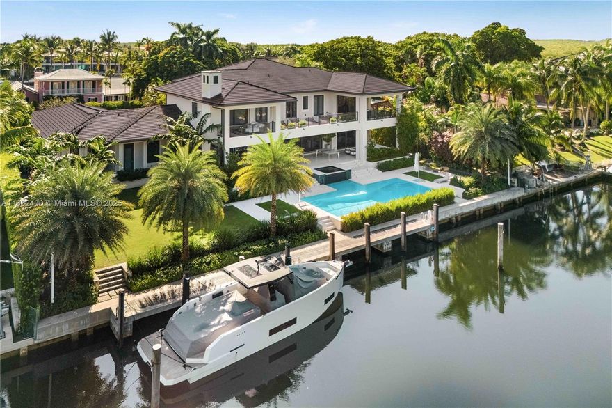 Welcome to a waterfront masterpiece, where contemporary sophistication embraces serene coastal living in prestigious & guard-gated Old Cutler Bay. Built in 2021, this exceptional estate showcases impeccable craftsmanship with hand-selected finishes from rich Russian white oak flooring to bespoke cabinetry and luxurious marble en-suite baths. Expansive floor-to-ceiling glass doors create seamless indoor-outdoor living, flooding the home with natural light while providing access to over 2,900 SF of covered terraces. Lush tropical landscaping envelopes the outdoor living space featuring a resort-style heated pool and spa and professional summer kitchen. This boater's paradise sits on 140' of pristine waterfront with dock space for a 100' yacht.
