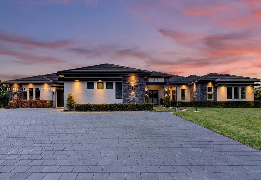 Discover luxury living in Southwest Ranches at this stunning 4-bed, 5-bath home. Inside, a gourmet kitchen with top-of-the-line appliances awaits, alongside whole-home comfort features like a generator and water filtration system. Stay secure with a pre-wired ADT system. Outside, enjoy a heated pool and expansive outdoor kitchen with electric shade. Modern conveniences include electric car chargers. With only 11 homes in the HOA, this community offers tranquility. Don't miss your chance to own a piece of paradise – contact us for a private showing today!