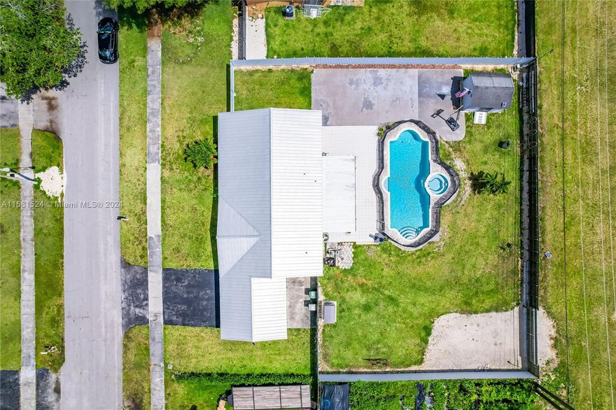 Welcome all, Here's a Great opportunity to own a nice home in a quit and peaceful area. The home features split plan four bedroom, two bath with double carport, tile floor throughout. Large fenced back yard, with a Fence in Pool! Equipped with Security System and stadium!! (360 View) 
This charming home boasts an OVERSIZED LOT (13,125 Sq.Ft) .
 The kitchen features wood cabinets, granite countertops with stainless steal appliances.
Also Home was upgraded with a New METAL ROOF in 2020 , High impact window it was fully remodeled !!

 NO HOA or CDD fees. Plenty of space for parking your toys