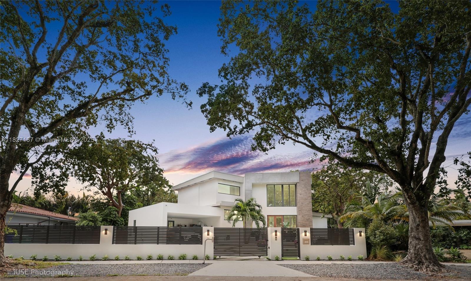 56 Samana Drive is a rare modern gem in Coconut Grove’s most exclusive enclave. Set on an oversized, nearly impossible-to-find lot, this 5,000 SF residence offers scale, serenity, and privacy minutes from top marinas, elite schools, and fine dining. Designed for seamless indoor-outdoor living, it features soaring 12' ceilings, expansive open-plan living and dining areas, and a custom chef’s kitchen with premium finishes. Resort-style salt and heated pool. The primary suite offers a spa bath, walk-in closet, and garden views. Three en-suite bedrooms provide comfort and privacy. The fifth bedroom is converted into flexible office/den/service quarters with a private entrance. Smart-home tech, gated driveway, 2-car garage, and 24/7 police patrol complete this exceptional residence.