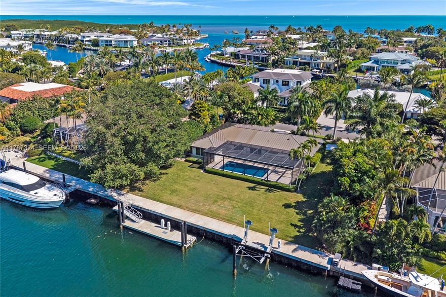 Tastefully remodeled canal front home in the heart of Ocean Reef Club. Move-in ready with 128’ of new concrete seawall (2022), 25,000 lb boat lift, floating dock, and room for a 92’ yacht. Features include high ceilings, ceramic floors, impact windows, remote shades, a speaker system, security cameras, and a metal roof (2019). The 2-car garage was added in 2022. Enjoy a resurfaced pool with a new screen enclosure and elegant glass railings. Lush landscaping and a brick driveway add to the curb appeal. Spacious lot offers room to expand. Easy to show and usually vacant. Survey available upon request.