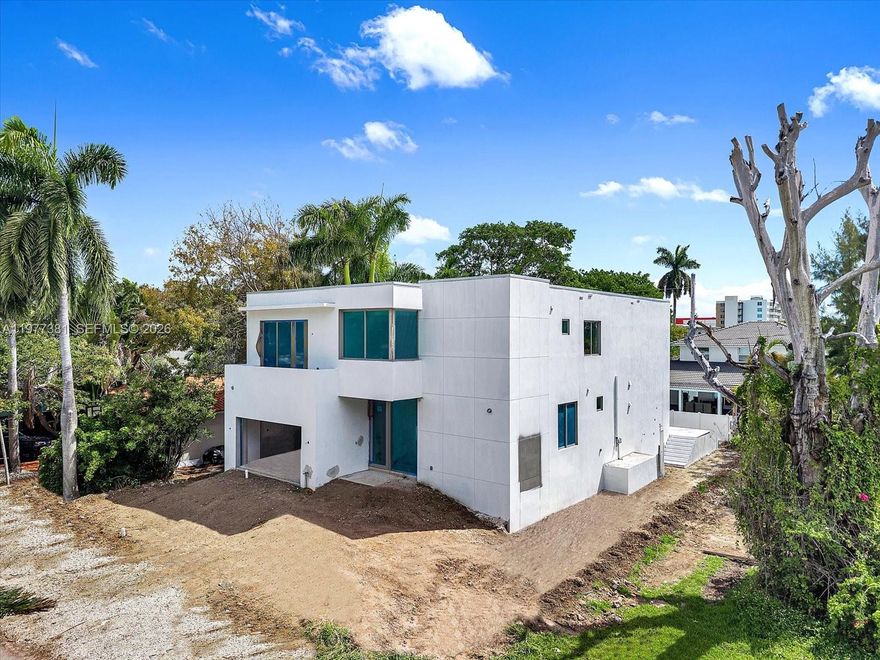 Discover this stunning new construction home in North Bay Village, thoughtfully designed for modern living. The residence features five spacious bedrooms, five full bathrooms, and an additional half bath across 4,410 square feet of beautifully crafted space.
The sleek contemporary exterior is complemented by expansive windows that flood the home with natural light. Inside, the open-concept layout is highlighted by floor-to-ceiling glass walls that showcase lush greenery and create seamless access to the private pool and patio—perfect for relaxing or entertaining guests.
Clean architectural lines run throughout the home, while the kitchen serves as a true centerpiece with a striking marble island and elegant fixtures that add a touch of everyday luxury. On track for April 15th completion.