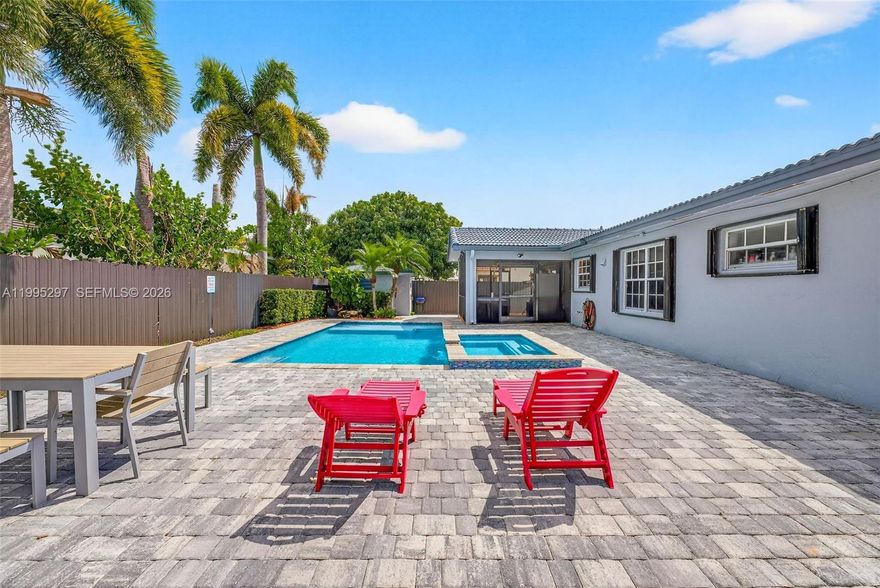 Exceptional opportunity in Mayte Subdivision (33187). Corner lot home with a large backyard designed for true outdoor living. The fully paved backyard features a saltwater heated pool with jacuzzi (2022), recently built and ideal for entertaining or enjoying South Florida weather year-round. The property also includes a newer deck and driveway (2022), a fully fenced yard, and a solid concrete structure perfect for storage or workspace. The lot offers ample parking for 4+ cars, plus side access ideal for a boat, trailer, or additional vehicles. Inside, the home offers a flexible layout with an additional living area and kitchenette, ideal for extended family or guests. The main living area provides comfortable living and dining spaces with a functional layout. Additional features include impact front and patio doors, accordion shutters, and a well-maintained roof. Conveniently located near major roads, shopping, dining, and schools. Priced to sell. All offers welcome.