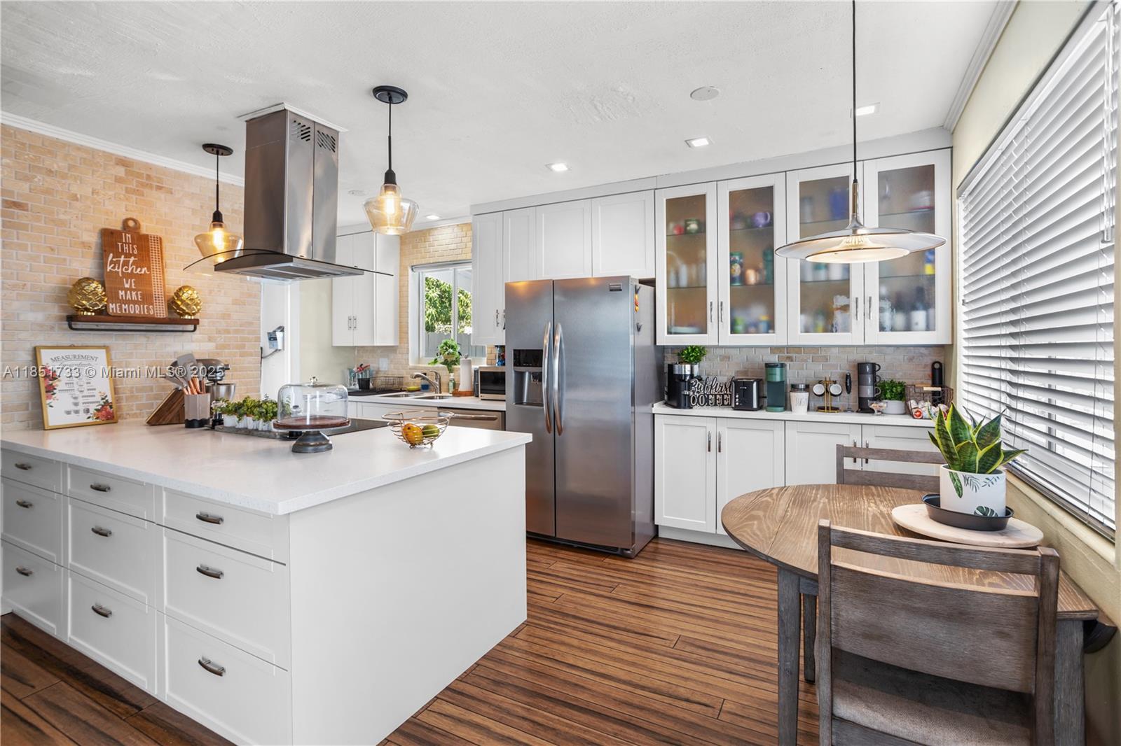 This completely remodeled, no-HOA Three-bedroom home near Whispering Pines features an open layout, white quartz kitchen with island, bamboo flooring, one bathroom, Large fenced yard with newly installed deck, shed, boat slip, and a mango tree. No HOA.