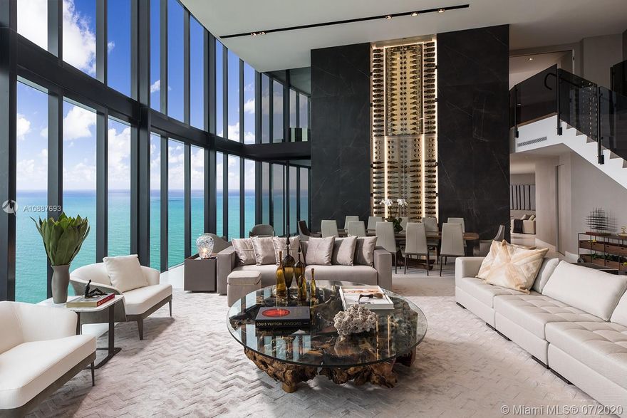 The finest residence at Porsche Design Tower! 5 bed /5.5 bath Trophy Mansion-in-the-Sky with interiors by Artefacto features 6,684SqFt & a 1,128SqFt, 4-car Sky Garage With Private Car Elevator so you can safely get into your 52nd floor Penthouse in complete privacy. Dramatic 21 ft ceilings, glass wine cellar, unobstructed ocean forever views, 3 living areas, private plunge pool, outdoor kitchen & 2 terraces complete the package. High tech upgrades include custom secured foyer entrance, Savant/Sonos AV system & electric shades. Porsche Design amenities include racing car & golf simulators, full-service restaurant, bar, room service, spa, pool & 200 ft on the ocean with beach service.