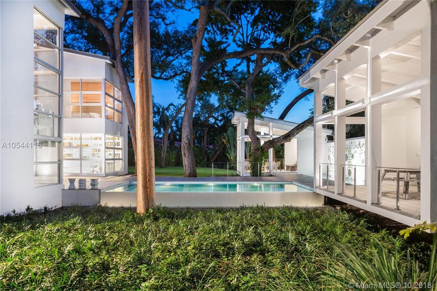 Built in 2015 and designed by Billy Blanco Designs, this sumptuous 6,317 sf modern style home incorporates an open floor plan, soaring ceilings and dramatic floor-to-ceiling windows to achieve its unique design. 2-story home boasting 5 beds, 6 full, 1 half baths includes separate Master wing with impressive spa like bath and closet. Floating outdoor kitchen, full bath and lounge overlook the infinity pool and lush half acre with amazing mature trees. Gourmet kitchen with Quartz countertops, Sub-Zero, Wolfe and Miele appliances with built-in barista system. Features include cove lighting, Terrazzo, Ash Wood flooring and wall panels. Wet bar with dual wine cooler. Light filled study. Spacious media room. Located on a quiet street, in the best section of Miami Shores, one block from the bay.