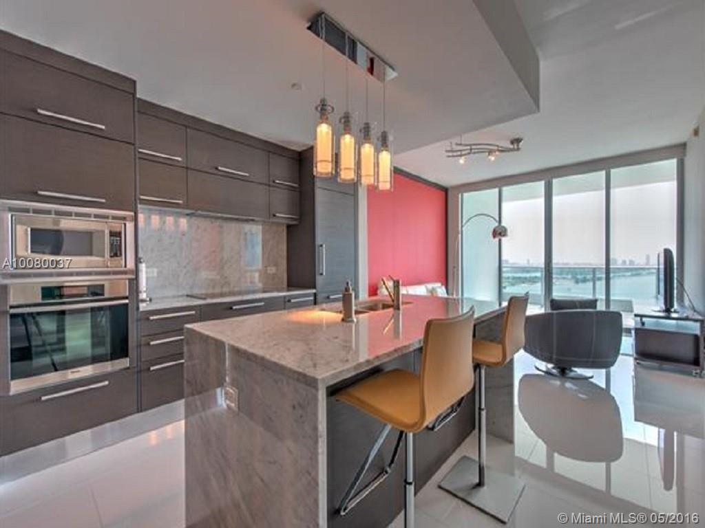 Like-New, 1 Bed/2 Bath + Den condo at 900 Biscayne Bay. Property has barely been used. Original owner. Never been rented. The 05 line is THE BEST 1 bedroom line in the building, offering complete privacy & full concrete walls on either side of unit. Showroom-quality condo w/ white tiled floors, electric shades in Liv Rm, large mirrors in both bathrooms & living room, built-in closets & beautifully partitioned den w/ built-ins. Breathtaking views of bay, ocean, sunrise, cruise ships & Miami Beach skyline.