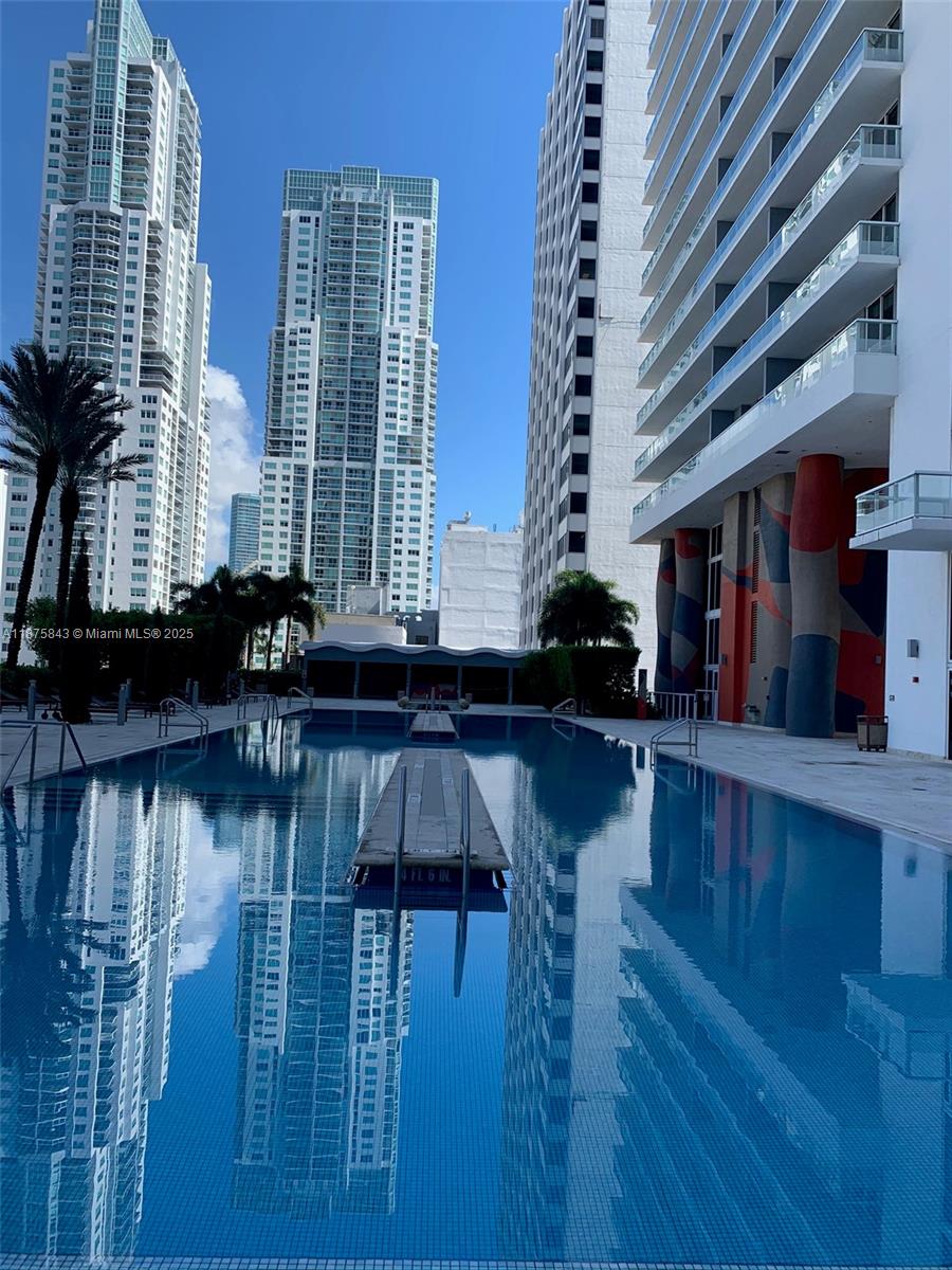 Welcome to upscale urban living in the heart of Downtown Miami. High-floor 1 bed + den, 1 bath offering 845 sq ft of thoughtfully designed space.
Bright, airy layout with floor-to-ceiling impact windows that flood the space with natural light and open to a traversing balcony boasting sweeping panoramic views of the city skyline.
Gourmet kitchen featuring all-teak cabinetry, sleek black granite countertops, and modern finishes throughout. A den, ideal for a home office, guest space, or creative studio.
Luxury amenities, including an infinity-edge pool, spa, and a state-of-the-art fitness center overlooking the bay. Located directly across from Bayfront Park, your steps from waterfront green space, shops, dining, and the best of Miami’s cultural scene.