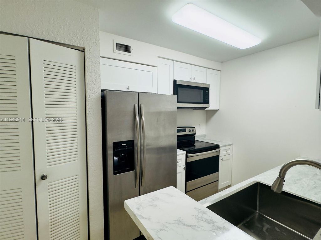 Photo of 2851 N Oakland Forest Dr #110, Oakland Park, FL 33309 (MLS # A11948914)