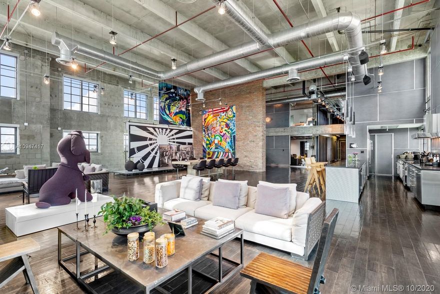 MANHATTAN MEETS MIAMI! NY style luxury loft living in the heart of Downtown Miami. Cutting-edge 7,110 sq.ft 5BR/5BA tri-level residence seamlessly integrates industrial aesthetic with state of the art modern amenities. 22 ft ceilings, dark oak hardwood floors, Creston Smart Home, Lutron lighting and 7 flat screen TVs surround 2,600 sq. ft of entertainment space. Top of the line open kitchen with Soapstone countertop, stainless steel double Wolf ovens, Subzero refrigerator/ 2 wine coolers. Private top floor Master boasts spacious walk-in his and her closets, double vanity sinks and ample room for seating area/hm office. Enjoy panoramic city views, sprawling living space and unparalleled attention to detail in the epicenter of Miami’s Arts & Entertainment District.