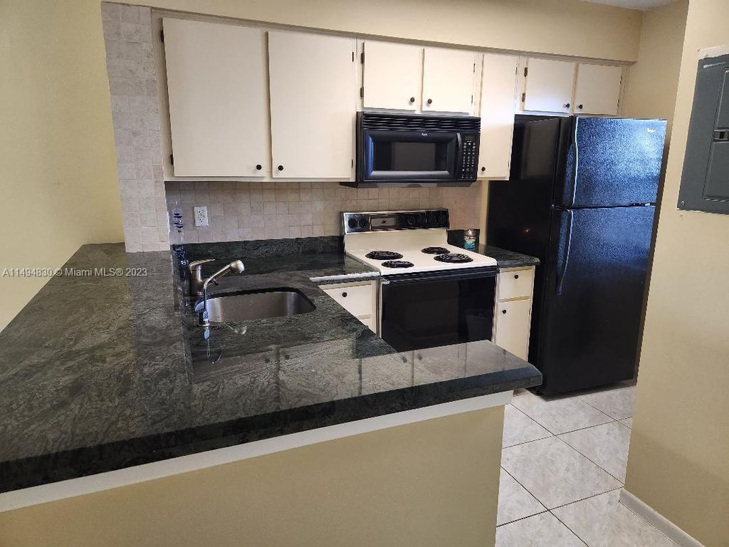 Photo of 2230 N Cypress Bend Dr #403, Pompano Beach, FL 33069 (MLS # A11494830)
