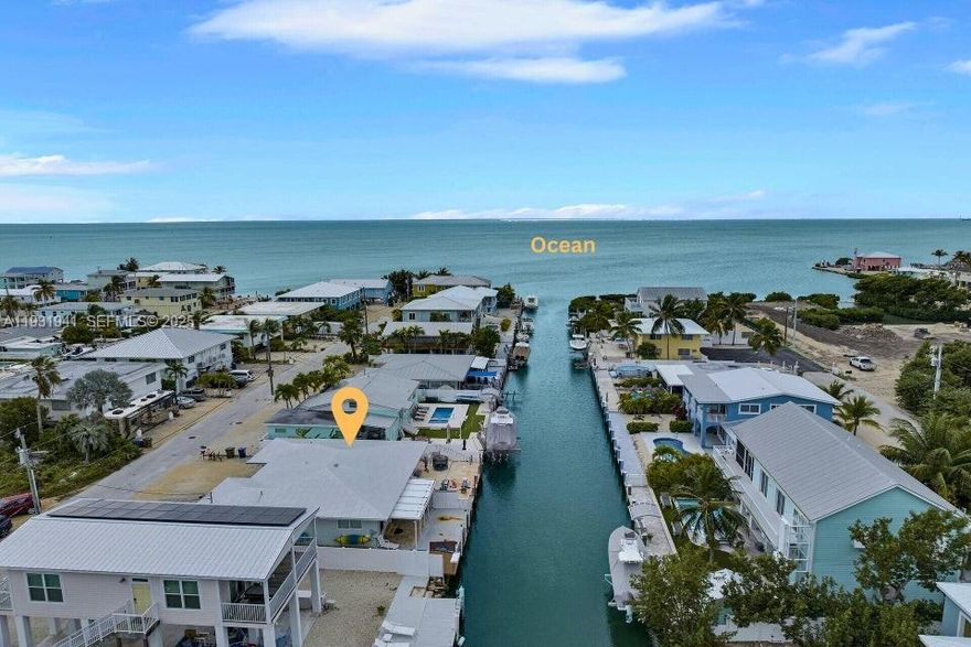 Step out to your private 35-ft dock on a clean, deep canal with quick ocean access from this solid CBS half-duplex. The open interior features tile flooring throughout and a granite kitchen designed for easy living. A 2018 metal roof adds durability, while the low-maintenance backyard offers a perfect space to relax or entertain. Enjoy minimal stairs and ample parking out front for added convenience. Ideally located in Marathon, the heart of the Florida Keys, this property is well suited as a full-time residence or a second home with excellent boating access.