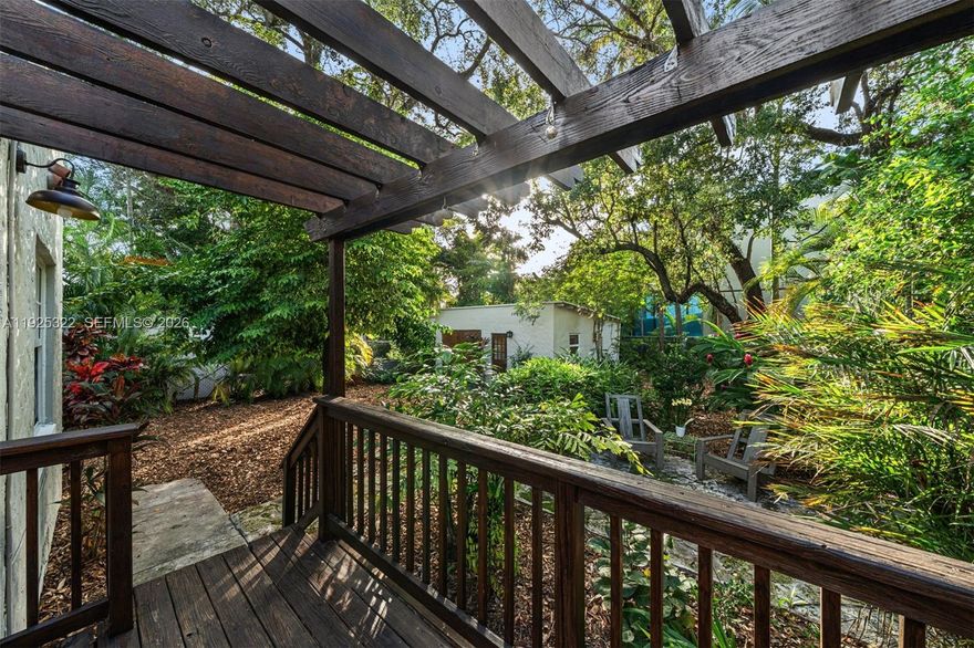 Welcome to this beautifully restored 1926 Mission Style residence, ideally set within the Pueblo Village enclave of Miami’s historic Spring Garden neighborhood. This 3-bedroom, 2-bath home spans 1,793 interior SQFT on a 7,650 SQFT lot and includes a detached garage currently configured as a flexible office or studio space. The home has been thoughtfully renovated and is move-in ready, while preserving hallmark architectural elements including irregular textured stucco, recessed windows, rounded corners, and signature cylindrical rain spouts. Impact windows have been installed throughout for peace of mind and efficiency. The lush backyard is framed by mature trees, offering a private garden atmosphere where butterflies are a frequent visitor. Set along wide, tree-lined streets near two neighborhood parks, Spring Garden delivers rare tranquility just minutes from Downtown Miami, Brickell, and Miami Beach.