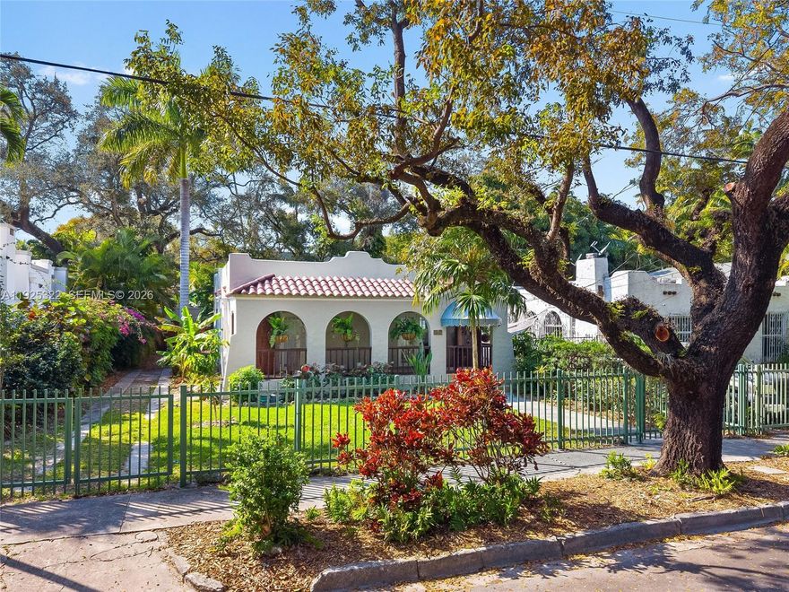 Welcome to this beautifully restored 1926 Mission Style residence, ideally set within the enclave of Miami’s historic Spring Garden neighborhood. This 3-bedroom, 2-bath home spans 1,793 interior SQFT on a 7,650 SQFT lot and includes a detached building currently configured to provide both a workshop and flexible office or studio space. The home has been thoughtfully renovated and is move-in ready, while preserving hallmark architectural elements including recessed windows, rhythmic arched doorways, original oak floors and a colorful tile fireplace hearth. Impact windows have been installed throughout for peace of mind and efficiency. The lush backyard is framed by mature oak and fruit trees, offering a private garden atmosphere where butterflies are a frequent visitor. Set along wide, tree-lined streets near two neighborhood parks, Spring Garden delivers rare tranquility just minutes from Downtown Miami, Brickell, and Miami Beach.