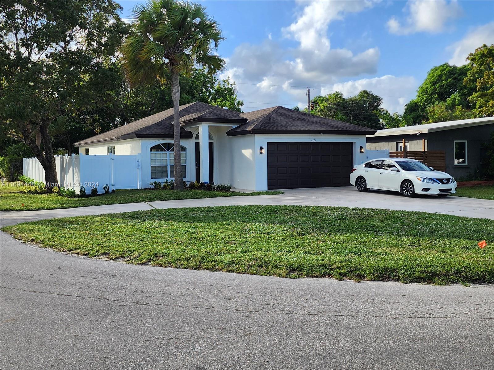 This remodeled 3-bed, 2-bath gem features a 2-car garage, new roof (2024), and new AC unit. Enjoy the ambiance of LED lights throughout and the durability of waterproof laminate floors. The interior and exterior have been freshly painted. Cook in style with quartz countertops and new appliances in the kitchen. The vinyl perimeter fence offers privacy, while the roofed terrace and covered patio provide ample space for relaxation. The spacious yard is perfect for a pool. Parking is never an issue with a driveway for 9 vehicles. Located near Wilton Manors, you're close to shopping, restaurants, and nightlife. This prime location won't last long. Easy to show.