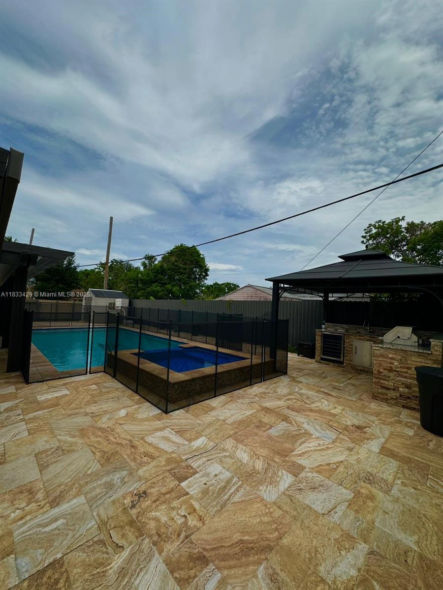 Beautifully remodeled 3-bedroom, 3-bathroom home offering a spacious open layout, modern kitchen with updated finishes, and turnkey condition—just move right in. This stunning property features a large private pool, fully equipped outdoor kitchen, and plenty of outdoor space perfect for entertaining or relaxing. With stylish upgrades throughout and no work needed, this home is ready to enjoy from day one.