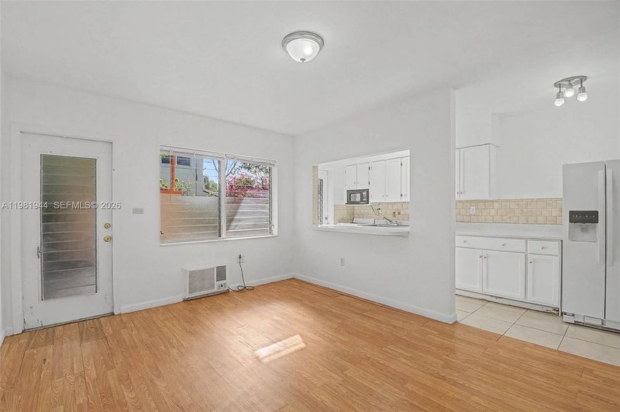 Corner one-bedroom apartment in Little River along the 79th Street corridor, offering abundant natural light and a functional open layout. The living area features laminate wood flooring with a pass-through to the kitchen, which includes white cabinetry and full appliances. The bedroom has generous built-in closet space. Water, sewer, and trash included in rent, tenants responsible for electric, cable/internet, and renter's insurance. On-site laundry available. Conveniently located near the Citadel Food Hall, Miami Design District, Wynwood, with easy access to I-95 and Miami Beach.