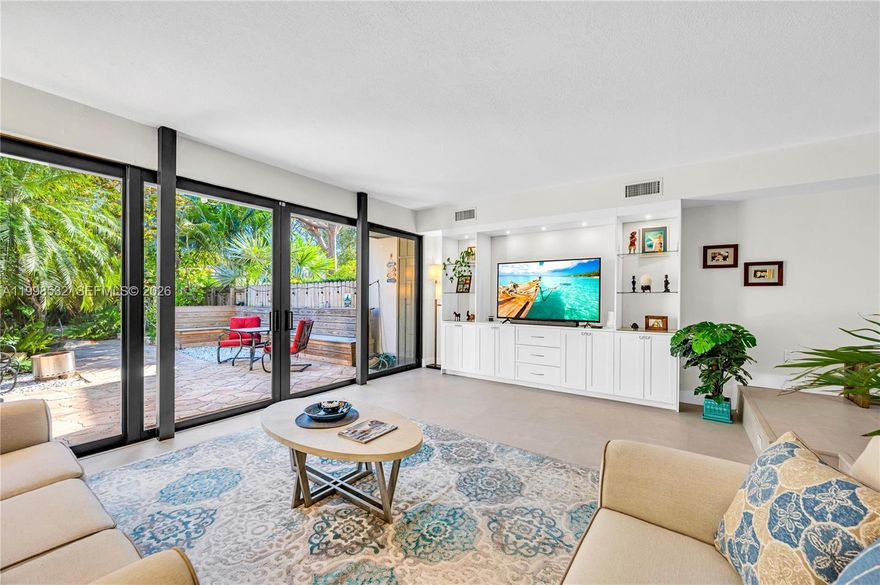 Welcome to this beautifully renovated, private townhouse in the highly sought-after gated community of Lake Ridge in Miami. Nestled within a lush, natural setting, this exceptional residence offers the perfect blend of tranquility and convenience. The home features a stunning white kitchen with new appliances, complimented by elegant porcelain floors throughout. A spacious living room opens seamlessly to a private, tree-lined patio with lush landscaping—ideal for indoor-outdoor living and entertaining. The ground floor also includes a bedroom and full bath, perfect for guests or flexible use. Upstairs, the expansive primary suite impresses with vaulted ceilings, a large walk-in closet, and a beautifully appointed bathroom featuring a generous walk-in shower. An additional upstairs bedroom offers its own ensuite bath, ample closet space, and a spacious layout. Lake Ridge is known for its serene, nature-filled environment, complete with a clean, usable lake, kayaking, tennis, and a waterfront pool. Enjoy peaceful strolls along the water while being just minutes from Coral Gables, the University of Miami, and a wide array of shopping, dining, and entertainment. A rare opportunity to enjoy refined living in one of Miami’s most desirable communities.