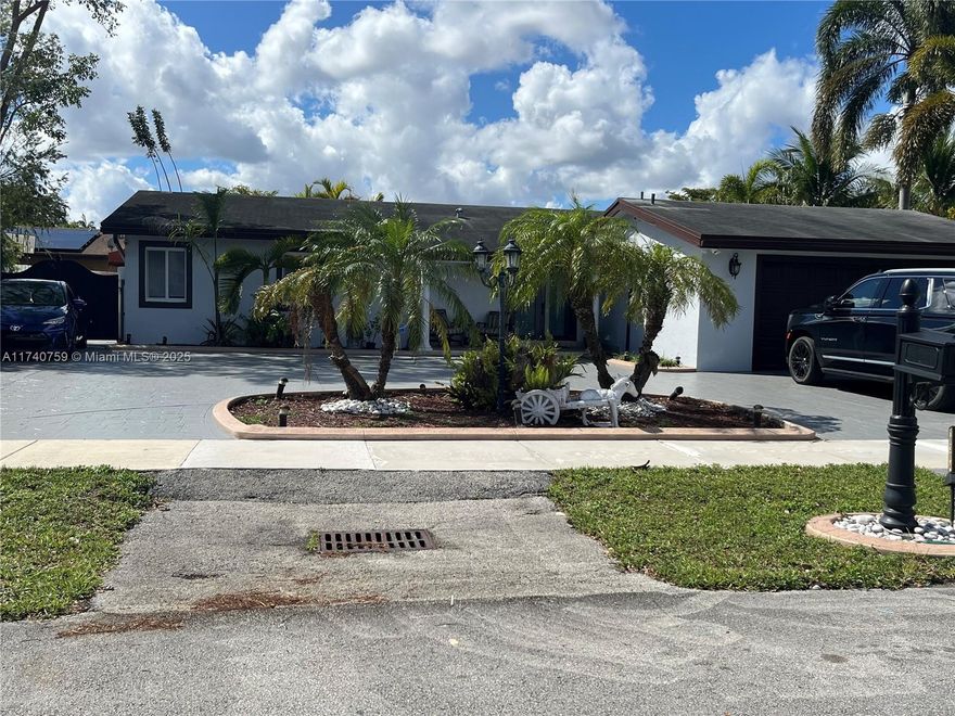 In the exclusive Calusa neighborhood, very well maintained dream home. Spectacular circular driveway. This home feature 3/2 plus in law quarter 1/1. The back yard is perfect for entertaining. Impact windows. NO HOA